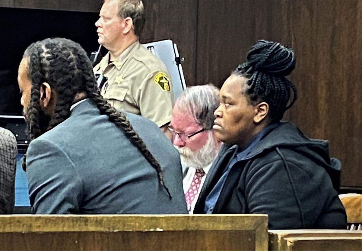 Courvoisia Wilson, right, sits in court with defense attorneys William Kendrick and Mark Shelnutt.