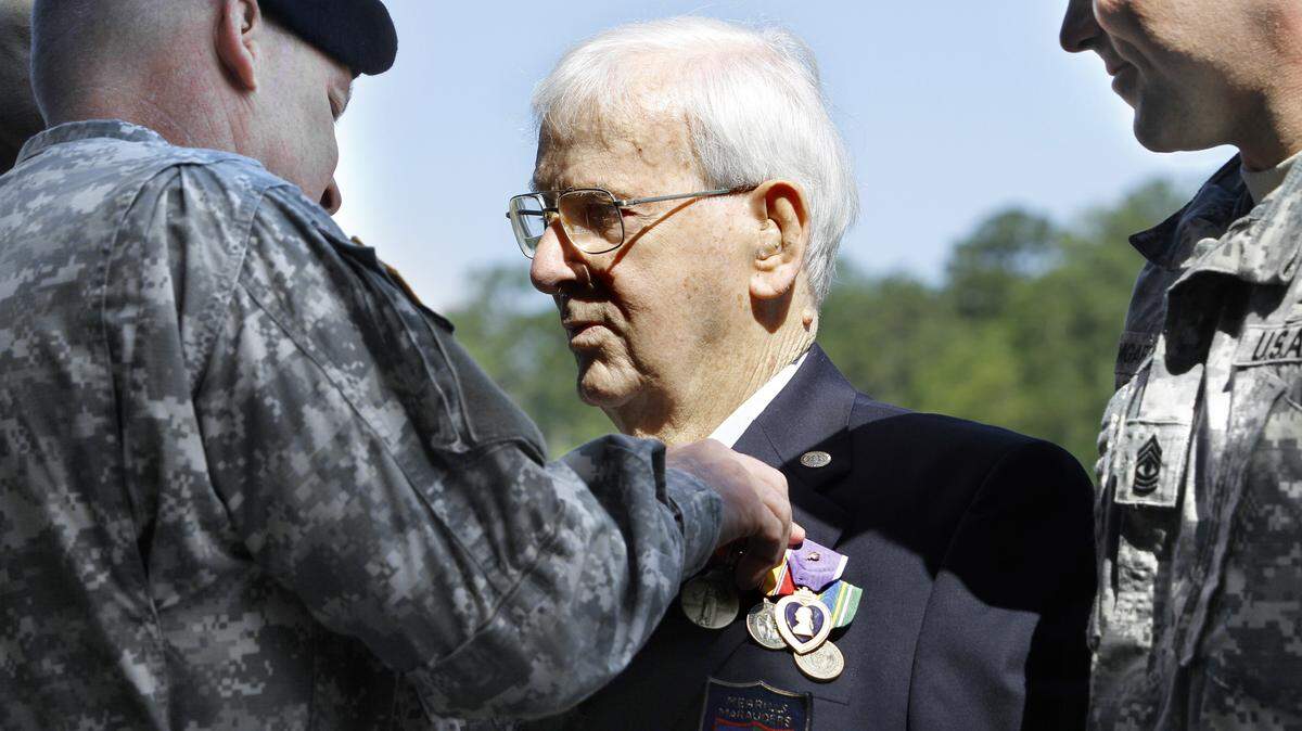 ROBIN TRIMARCHI rtrimarchi@ledger-enquirer.co 
 Brig. Gen. David Haight, left, pins six medals on retired Master Sgt. Vincent Melillo during graduation ceremonies at the Ranger Training Brigade's Hurley Hill Friday. The 94-year old World War II veteran was an original member of Merrill's Marauders, the forerunners of the U.S. Army Rangers. The medals commemorate five campaigns from WWII and the Korean War. Melillo was also awarded the Ranger Tab. 04.26.13