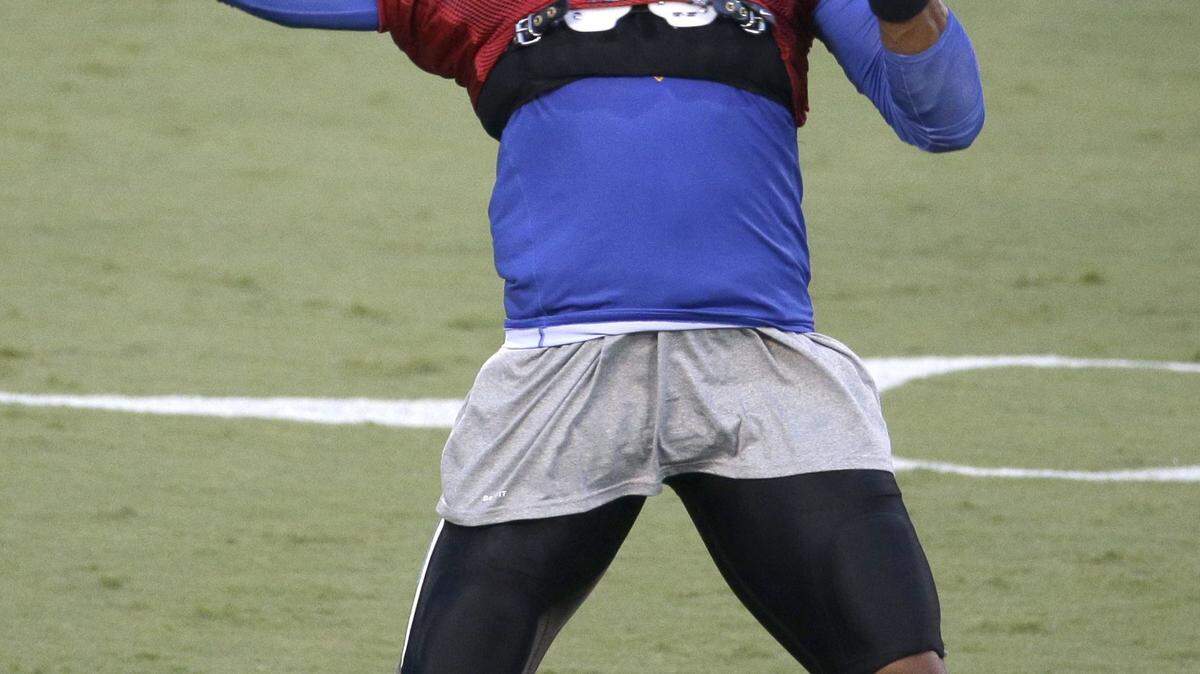Carolina Panthers' Cam Newton prepares to throw a pass during the annual Fan Fest at the NFL football team's training camp in Charlotte, N.C., Friday, Aug. 7, 2015. (AP Photo/Chuck Burton)