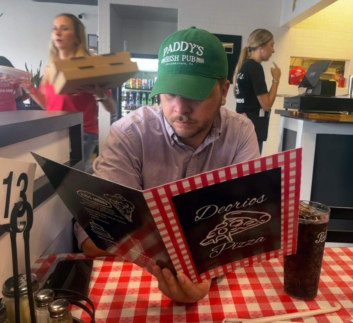 Ledger-Enquirer reporter Kelby Hutchison looks over the menu at Deorio’s Pizza Friday in Columbus, Georgia. 08/09/2024