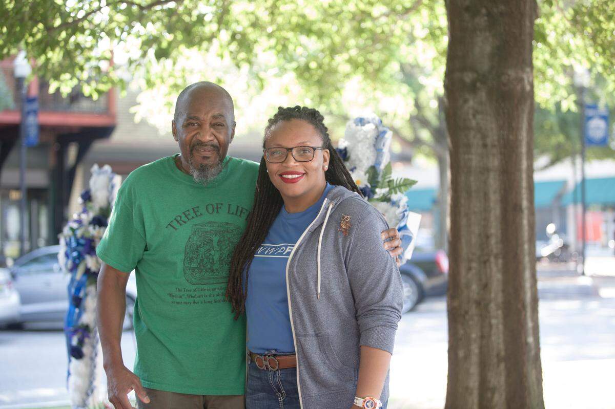 Johnnie Warner, left, and LaKesha Stringer stand at the site of a memorial Warner placed on Broadway and 11th Ave in Columbus, Ga, on June 17, 2021. Both are advocating for a historic marker of the 1896 double lynching of Jesse Slayton and Will Miles.