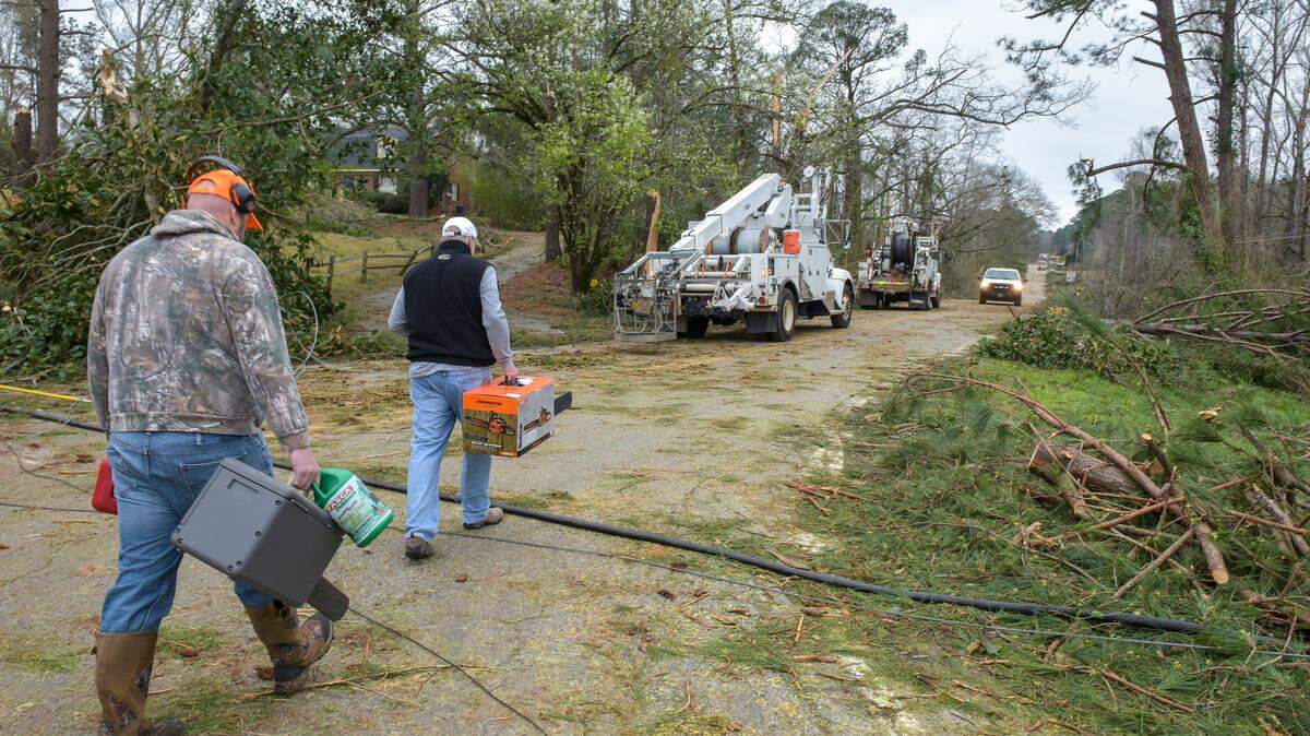 Repair crews working to clear storm damage along Biggers Road Monday morning March 4, 2019 after tornadoes came through the area Sunday afternoon