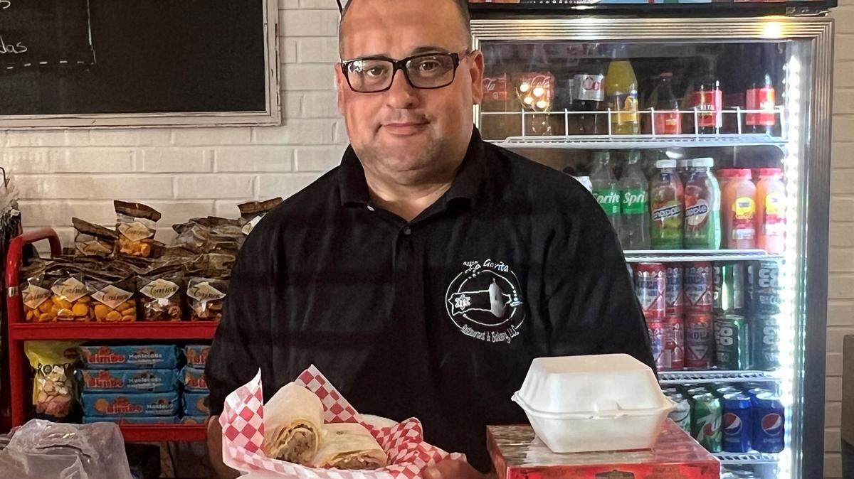 Federico Veguilla prepares a Cuban sandwich for a customer at La Garita Restaurant & Bakery located on Fort Benning Road.