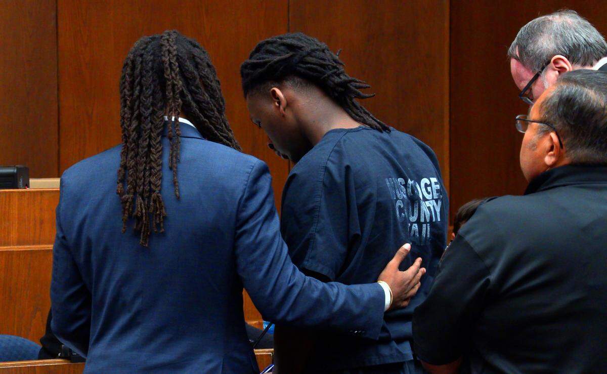 William Kendrick, left, defense attorney for William Cross, center, speaks with Cross Monday morning during a hearing before Superior Court Judge Arthur L. Smith III. Cross pleaded guilty Monday morning to several charges related to the death of Carver High School baseball coach David Pollard on April 18, 2016 in Columbus, Georgia.