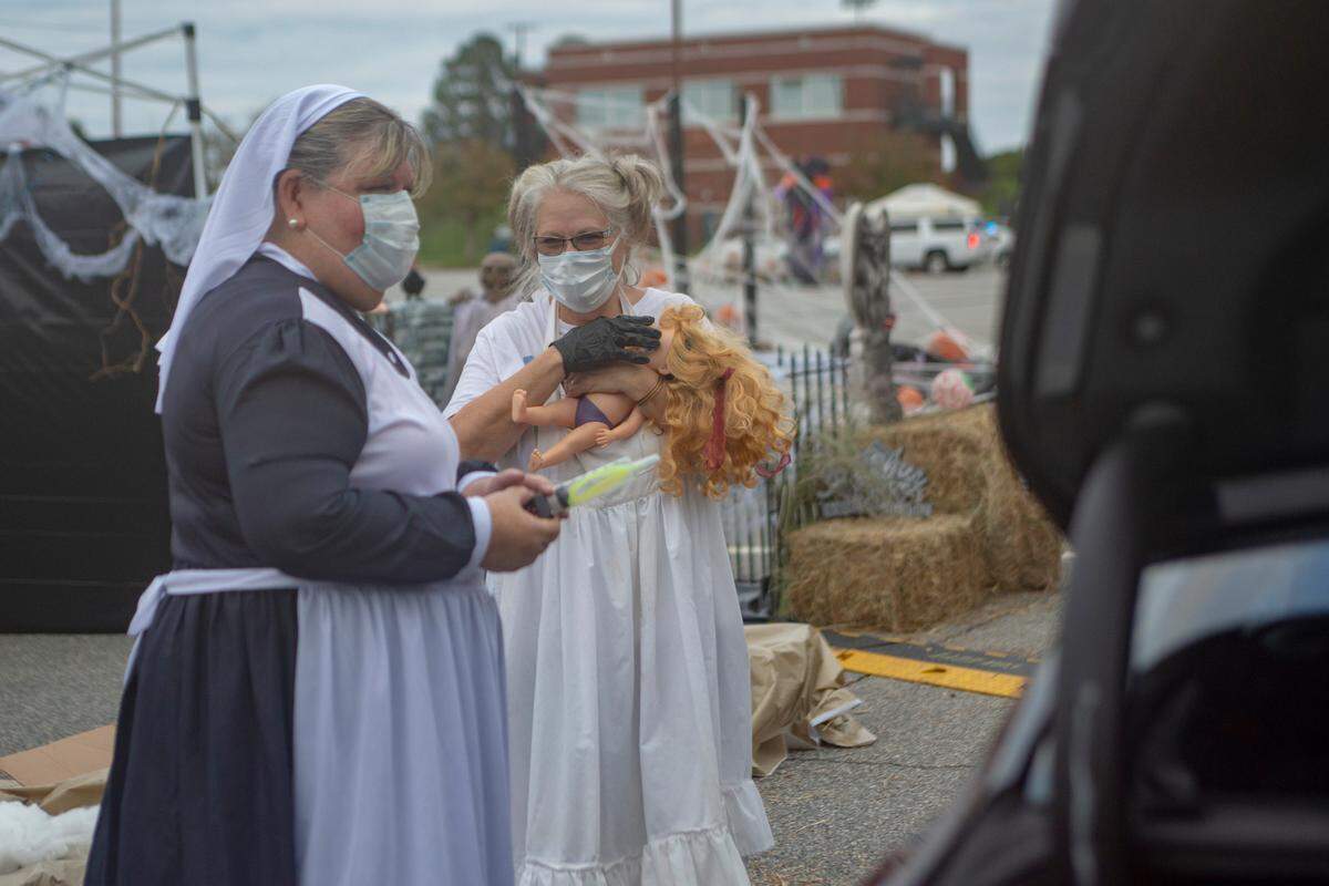 Parks and Recreation employees Melinda Hall and Diane Giles roleplay frightening characters during the Spooktacular Trunk or Treat event on Sunday, Oct. 25, 2020 at the Civic Center in Columbus.