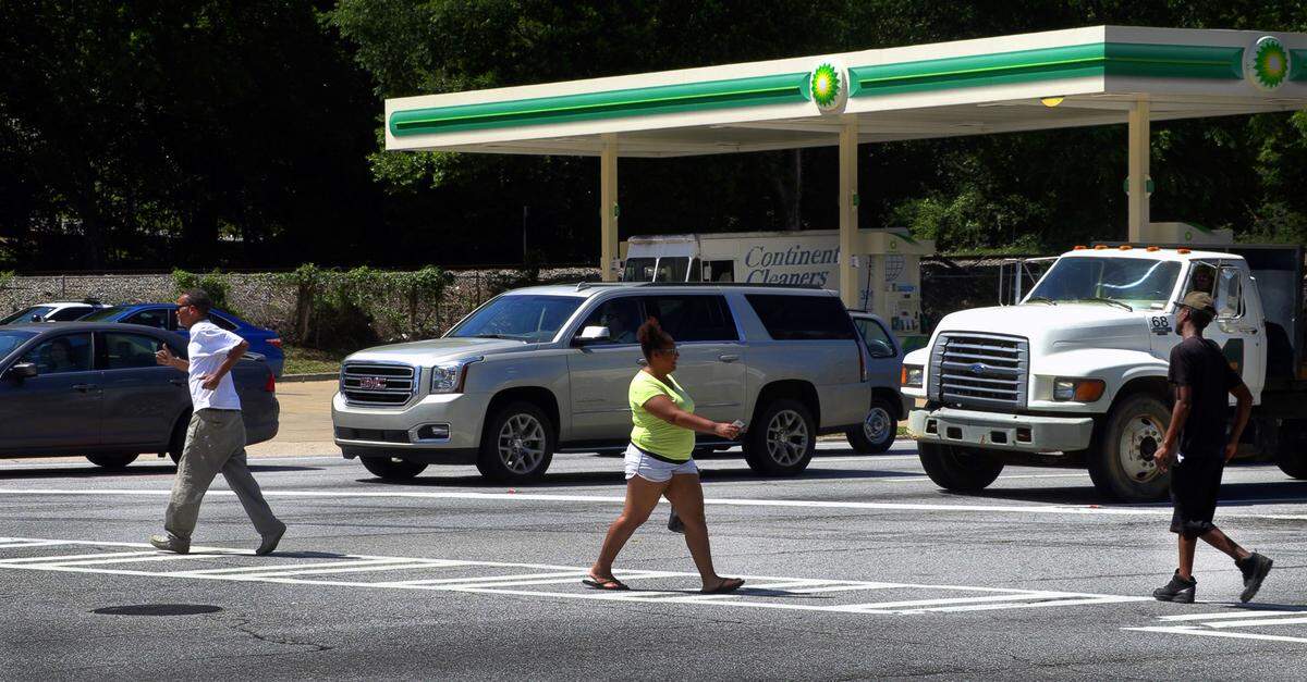 Pedestrians use the crosswalk and crossing lights to legally cross Veterans Parkway at 23rd Street in Columbus, Ga.