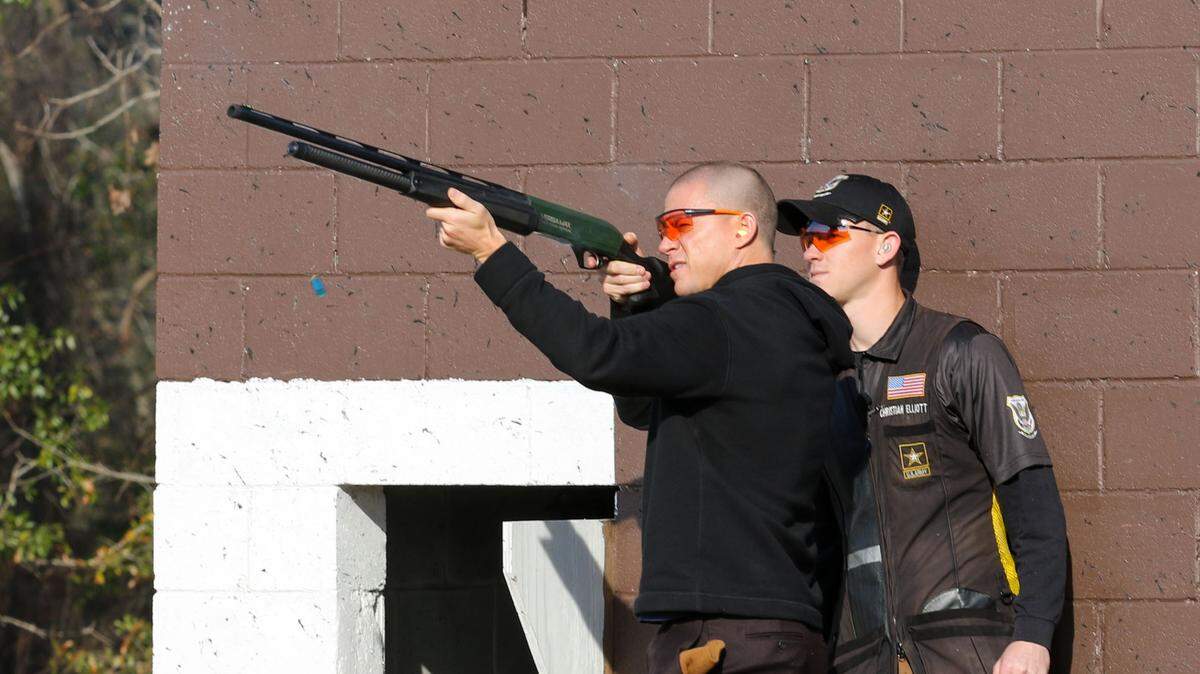 Channing Tatum fires a shotgun after a demonstration by the U.S. Army Marksmanship Unit at Fort Benning, Ga. on Feb. 11, 2022. Tatum visited to promote his new movie ‘Dog.’