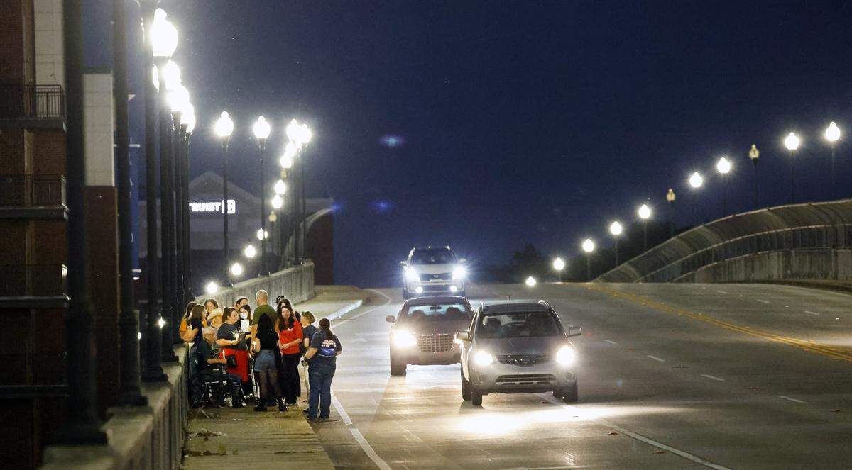 People gather Sept. 4, 2025, on the 13th Street Bridge, which connects Columbus, Georgia, to Phenix City, Alabama, for a candlelight vigil to remember and honor victims of gun violence. The event was organized by Phenix City Indivisible, Columbus, GA Indivisible and the Under the Muscadine Catholic Worker community.