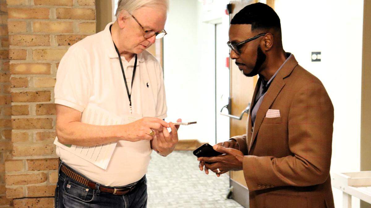 Pastor Bob Farrow of St. Nicholas Episcopal in Hamilton, Georgia and Pastor Willie J. Barber II of Prospect A.M.E. meet and share contact information at the Green Team Summit.