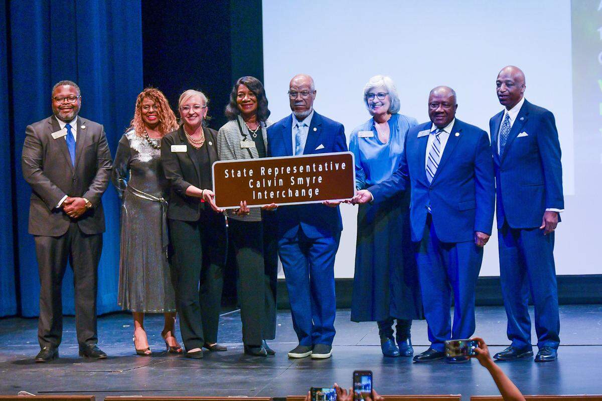 Former state Rep. Calvin Smyre of Columbus is joined on the Rainey-McCullers School of the Arts stage by members of the local legislative delegation Dec. 18, 2024, at the ceremony celebrating the naming of the intersection of I-185 and Macon Road as the Calvin Smyre Interchange.