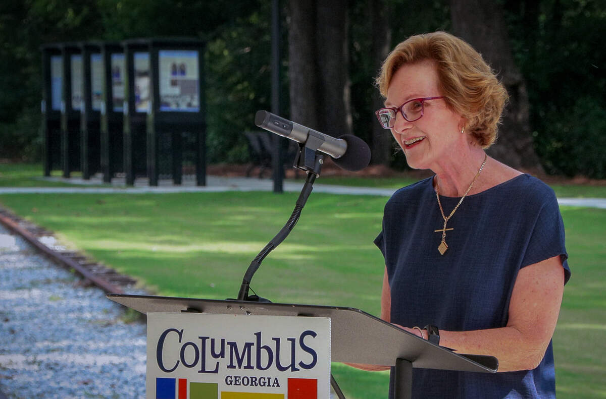 Catherine Trotter, president-elect of the Historic Columbus board, speaks to people attending the June 11, 2026, opening ceremony and ribbon cutting for the Chattahoochee Promenade and the Clifford & Bobsie Swift History Trail in Columbus.
