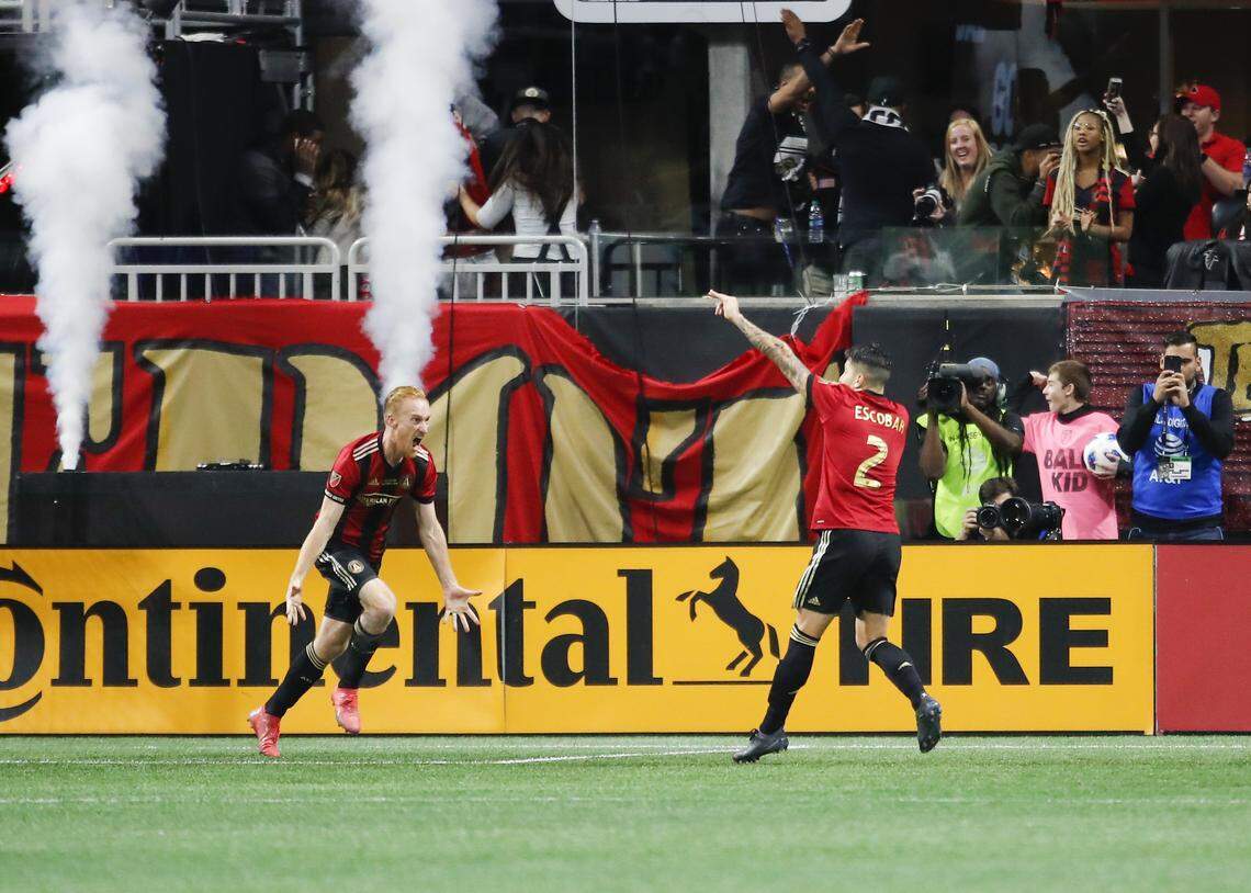 Atlanta United’s Franco Escobar (2) celebrates a score with teammate Jeff Larentowicz in the second half of the MLS Cup championship soccer game against the Portland Timbers on Saturday in Atlanta.