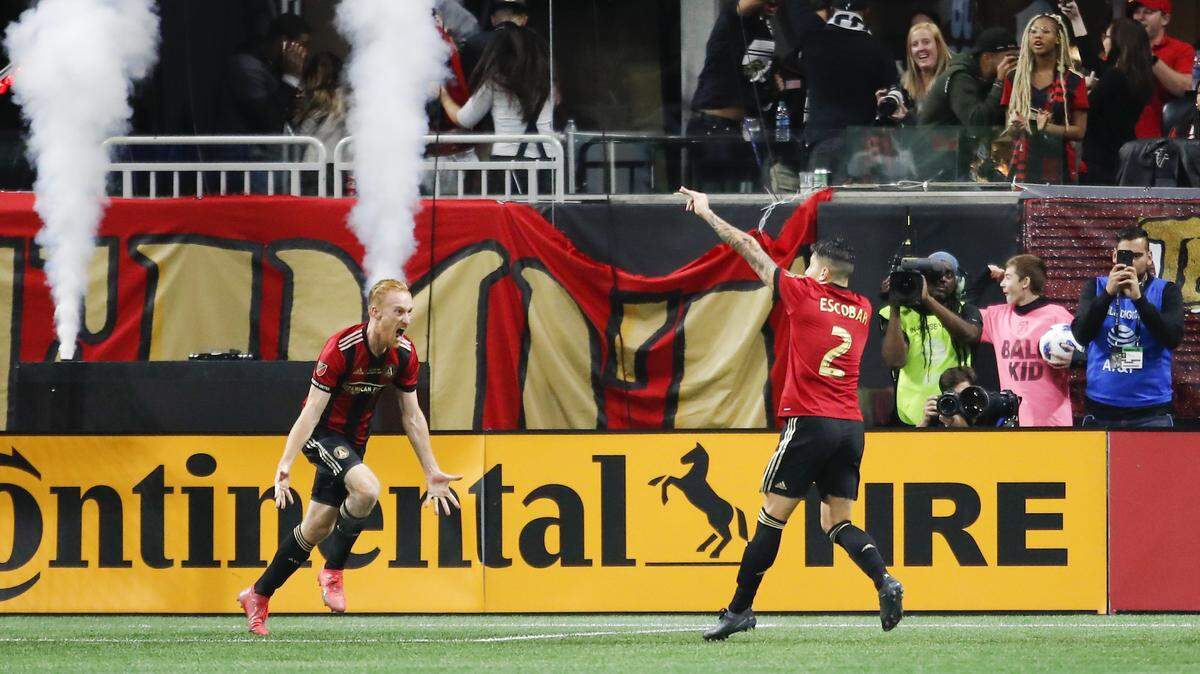 Atlanta United’s Franco Escobar (2) celebrates a score with teammate Jeff Larentowicz in the second half of the MLS Cup championship soccer game against the Portland Timbers on Saturday in Atlanta.