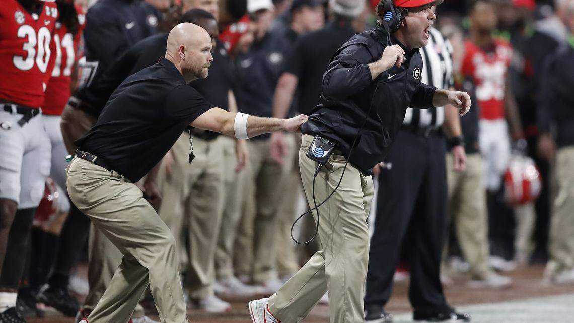 So who is that guy who keeps grabbing Kirby Smart’s pants on the sideline?