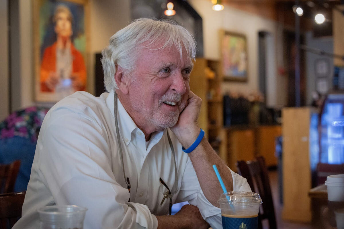 “Theo of Golden” author Allen Levi talks with customers inside Fountain City Coffee in Columbus on June 25, 2026.