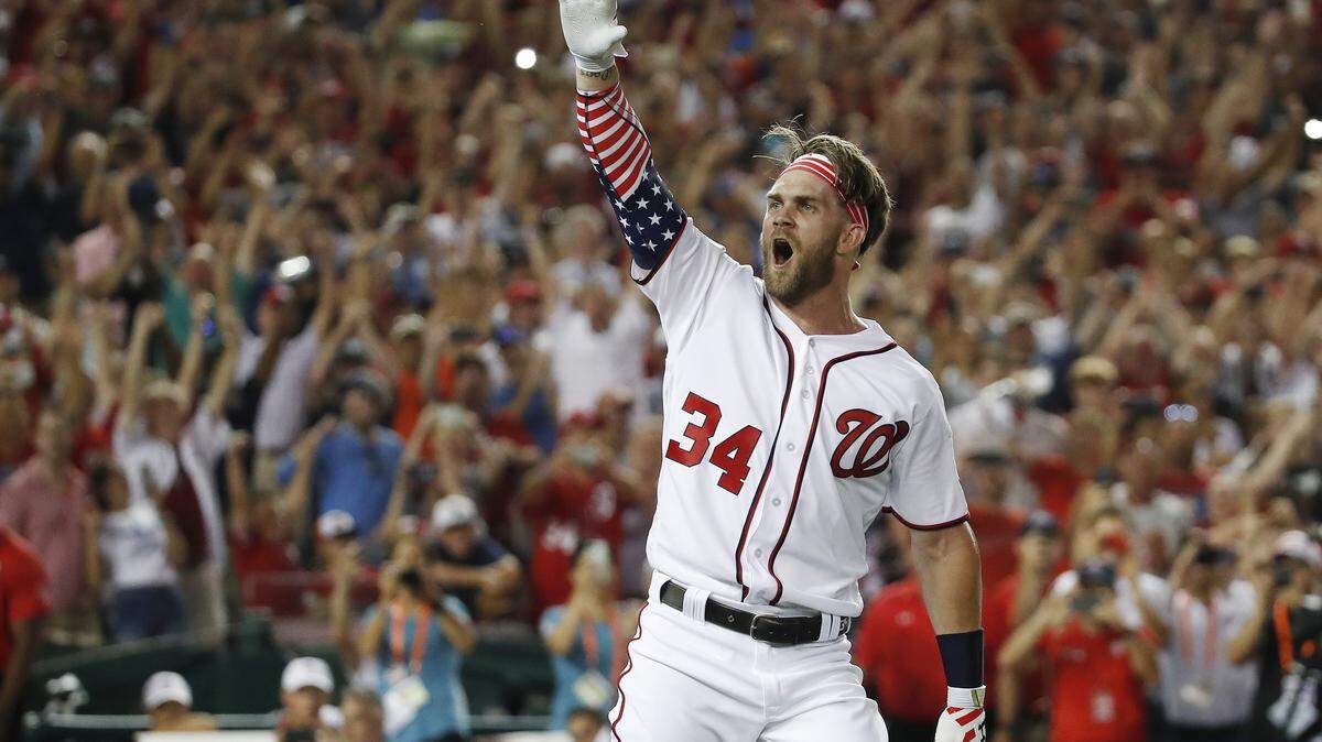 FILE - In this July 16, 2018, file photo, Washington Nationals Bryce Harper (34) reacts to his winning hit during the Major League Baseball Home Run Derby, in Washington. A person familiar with the negotiations tells The Associated Press that Bryce Harper and the Philadelphia Phillies have agreed to a $330 million, 13-year contract, the largest deal in baseball history. The person spoke to the AP on condition of anonymity Thursday, Feb. 28, 2019, because the agreement is subject to a successful physical. (AP Photo/Alex Brandon, File)