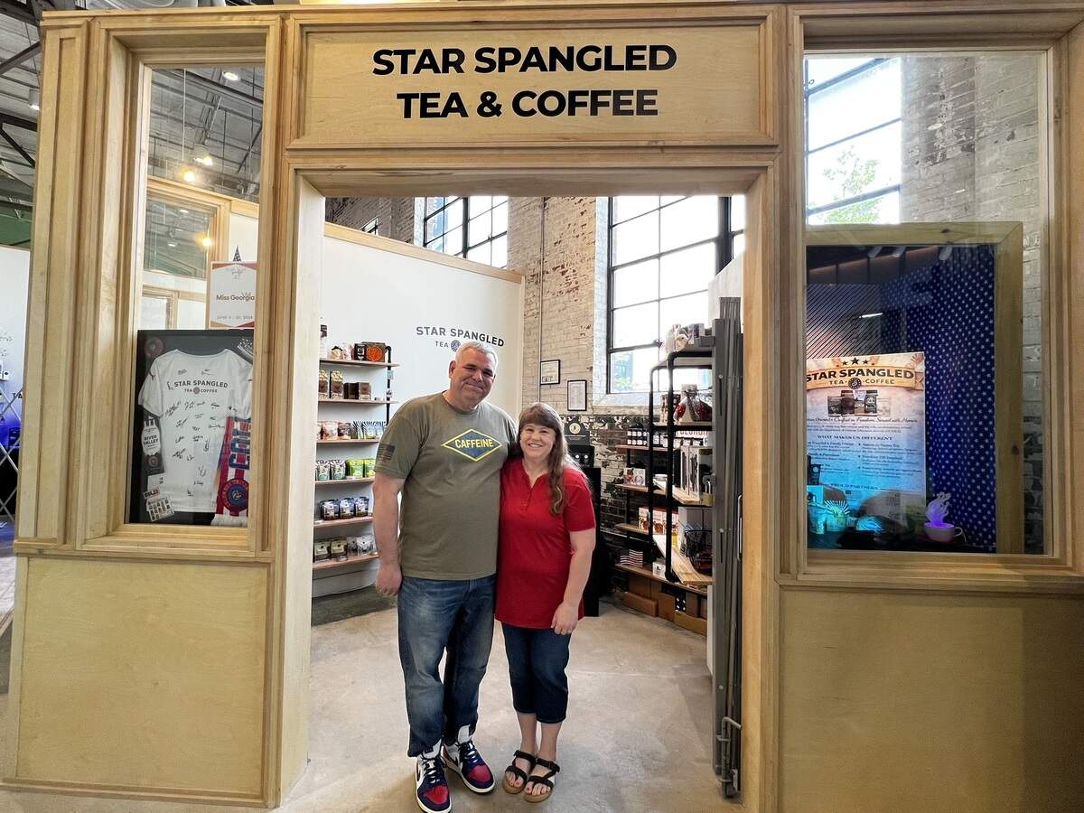 Star Spangled Tea & Coffee owners Roger and Aimee Owens stand in the entrance of their shop, which opened in January 2026 at Highside Market in Columbus.