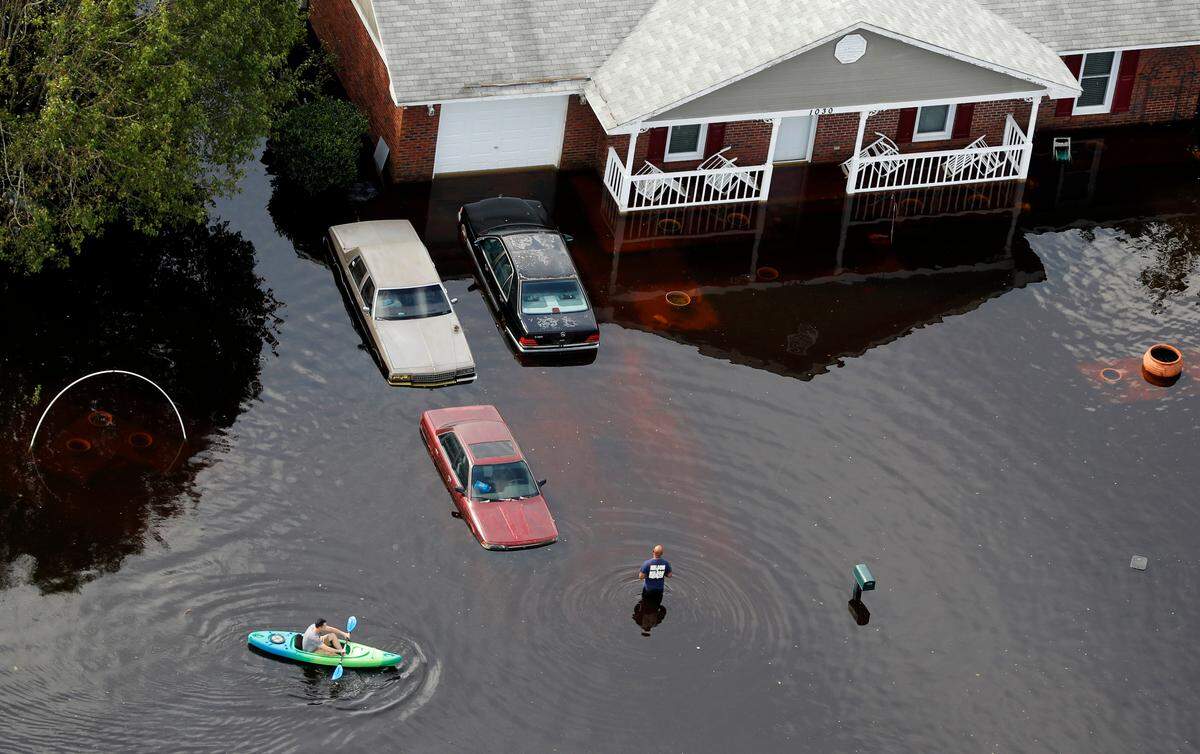 A man paddles a kayak in a flooded neighborhood in the aftermath of Hurricane Florence, in Fayetteville, N.C., on Monday.