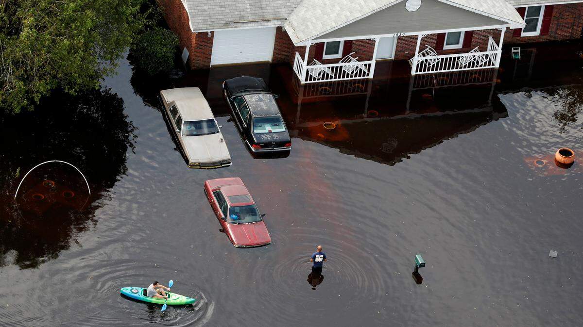 A man paddles a kayak in a flooded neighborhood in the aftermath of Hurricane Florence, in Fayetteville, N.C., on Monday.