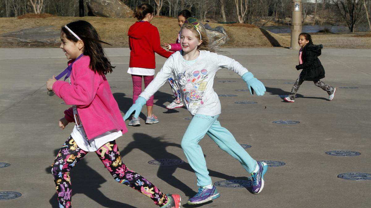 ROBIN TRIMARCHI rtrimarchi@ledger-enquirer.com 
 Youngsters play in the splash pad during the Junior League Mardi Gras Madness runs at Woodruff Park Saturday. The 6th annual 1-mile and 5K race drew about 180 runners, with about 50 of them between 2 to 12 years old. The organization's next event is The Follies on March 4 at the RiverCenter for the Performing Arts.