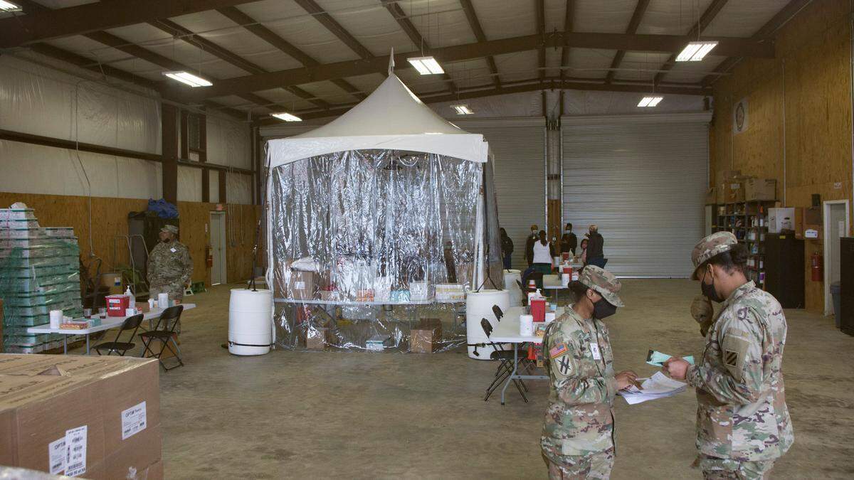 National Guard troops stage the new mass vaccination site in Albany, Ga. on Feb. 19, 2021. Four cars will fit inside the unit and healthcare workers will vaccinate the drivers.