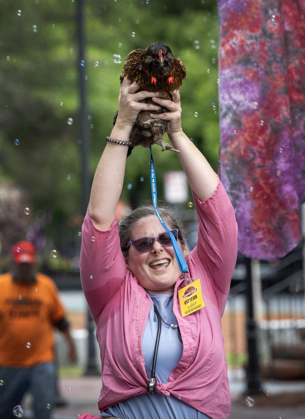 Holding her chicken aloft, Nicole de Vries marches in the 2026 Strut the Hooch parade May 2 in Columbus.