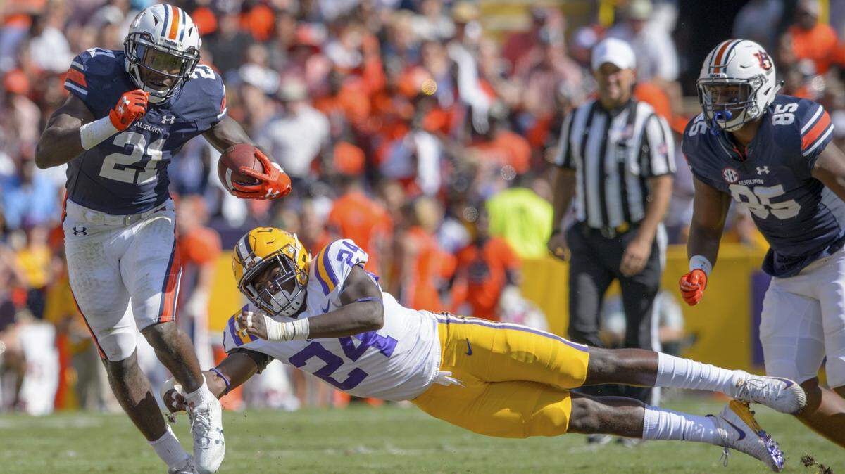 Auburn running back Kerryon Johnson (21) rushes against LSU linebacker Tyler Taylor (24) in the first half during an NCAA college football game in Baton Rouge, La., Saturday, Oct. 14, 2017