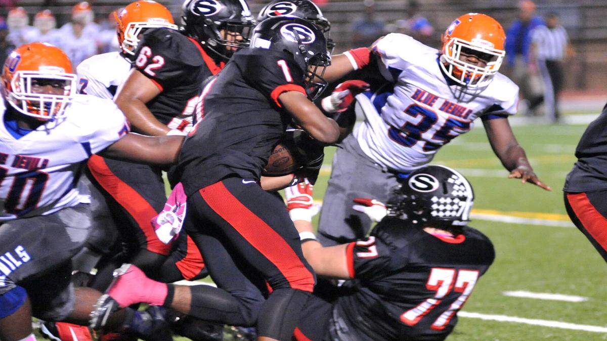 Shaw's Sydarrian Cobb running though the Columbus defenders on a 1st down carry late in the 2nd quarter of the game Friday night October 9, 2015 at Kinnett Stadium