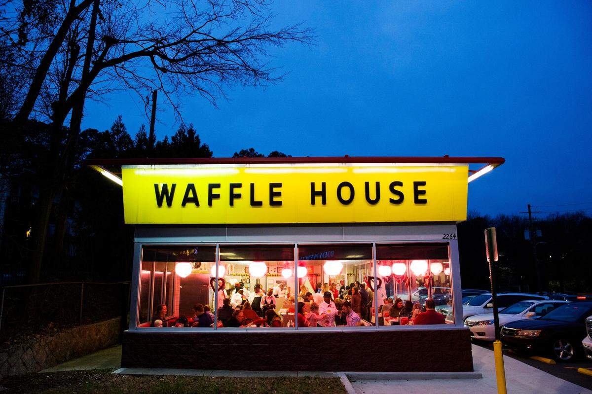 Diners eat at a Waffle House restaurant decorated for Valentine’s Day in Atlanta, Wednesday, Feb. 14, 2018. The famous Southern diner chain creates a romantic atmosphere with soft music, white tablecloths, and candlelight dinner in 170 of their restaurants for the annual holiday.