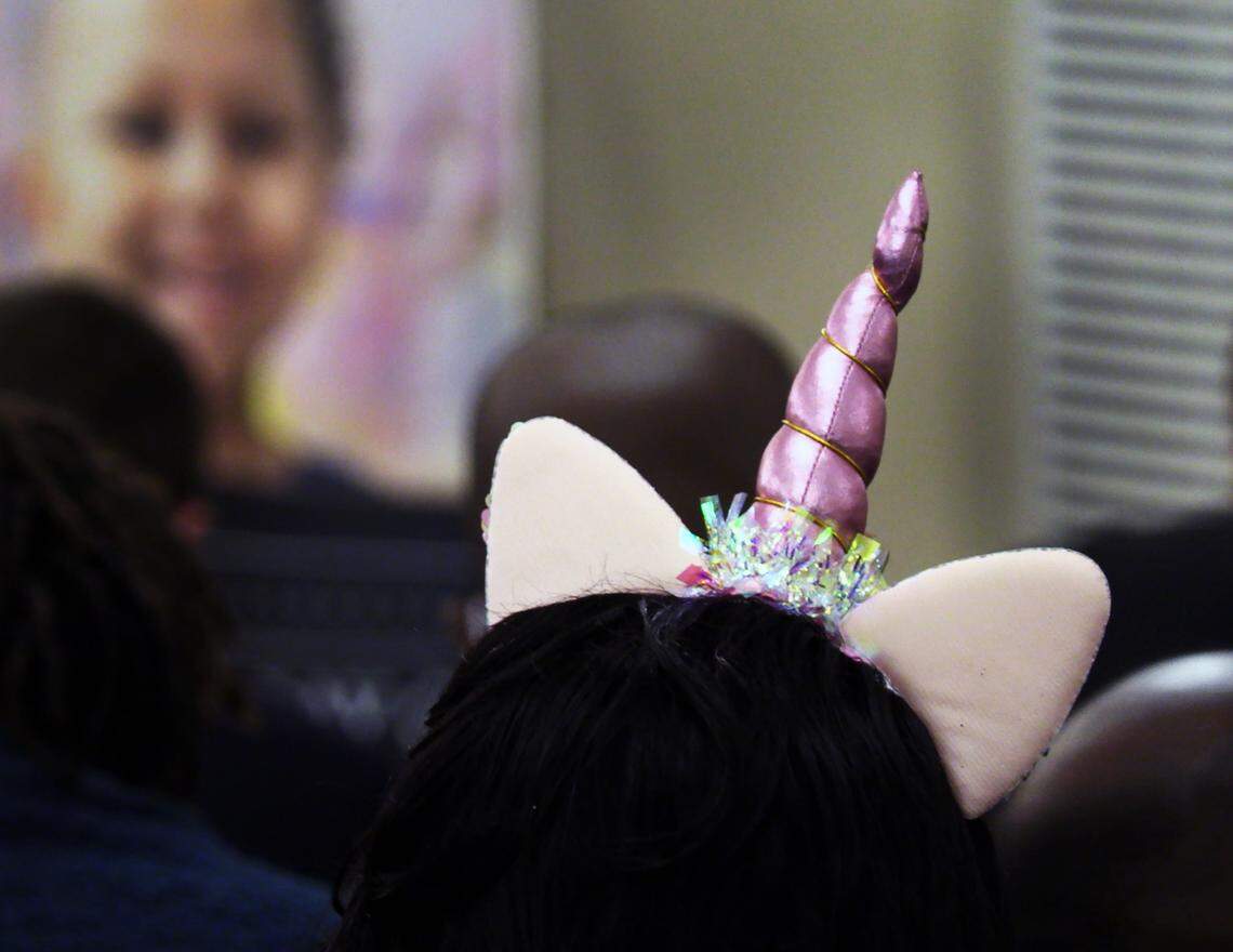 A young girl attending the funeral service for Kamarie Holland wore a unicorn headband in honor of Holland. 12/22/2021