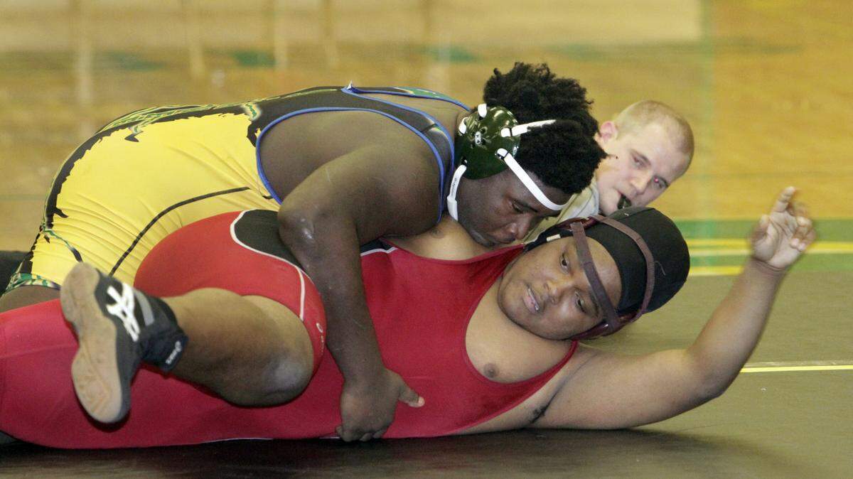 ROBIN TRIMARCHI rtrimarchi@ledger-enquirer.com 
 Spencer High's Christophe Baker pins Latayvion Favor of Jordan High in the Area 2-AAA wrestling championships Saturday at Spencer High to qualify for the state tournament in the unlimited weight class. 01.09.10