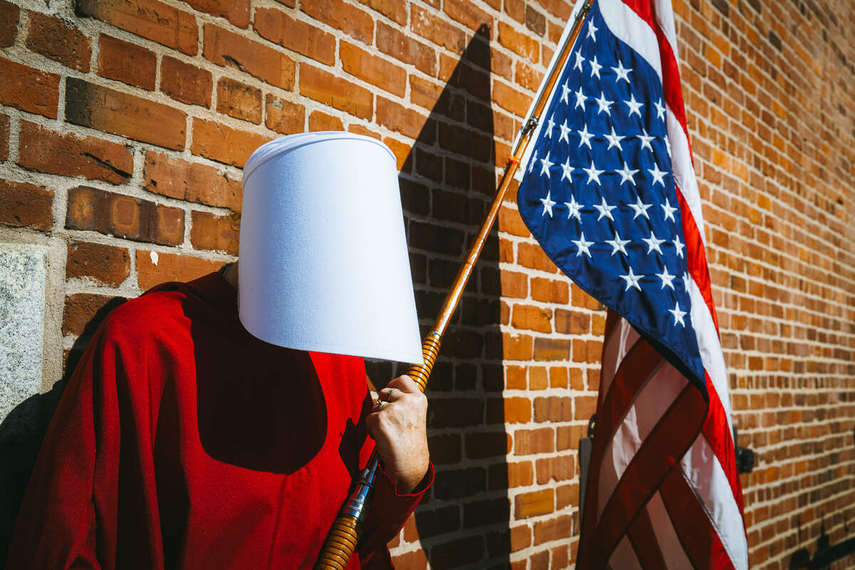 Cindy Richards uses the red cloak and white hood from The Handmaid’s Tale as a protest for the erosion of women’s rights.