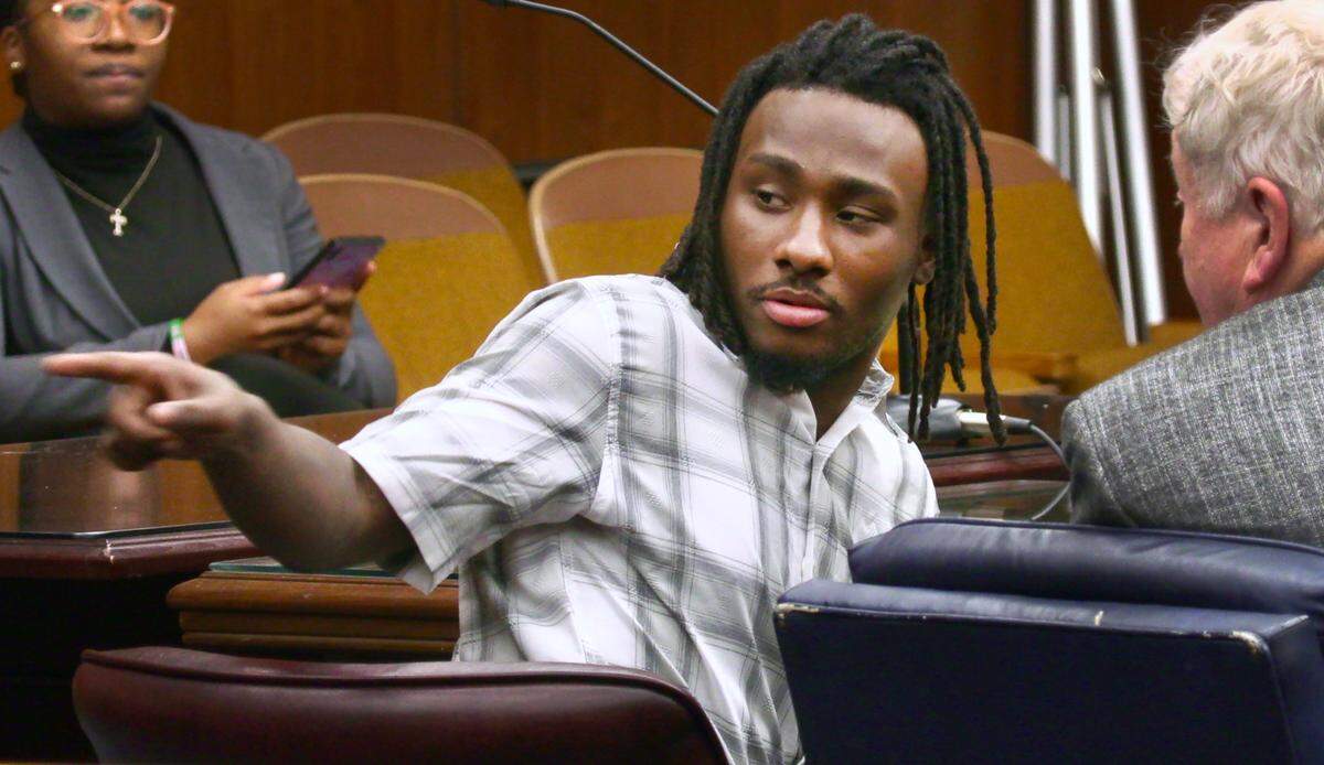 Lydell Maynard “Trapa” Sparks, center, motions to the back of the courtroom while waiting for court to resume Tuesday afternoon. 06/14/2022