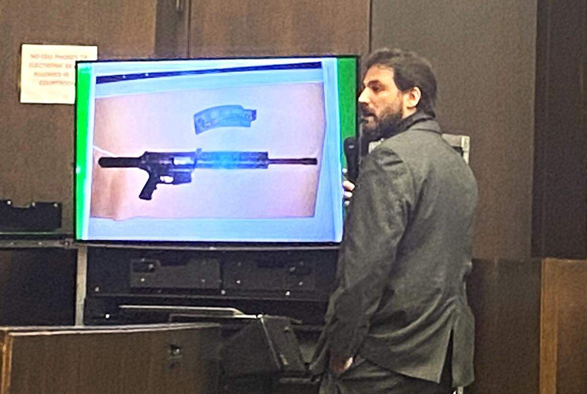 Police Sgt. Jerry Yarborough tells jurors about the rifle police found in the lap of a dead teenager in a bullet-riddled Dodge Dart.