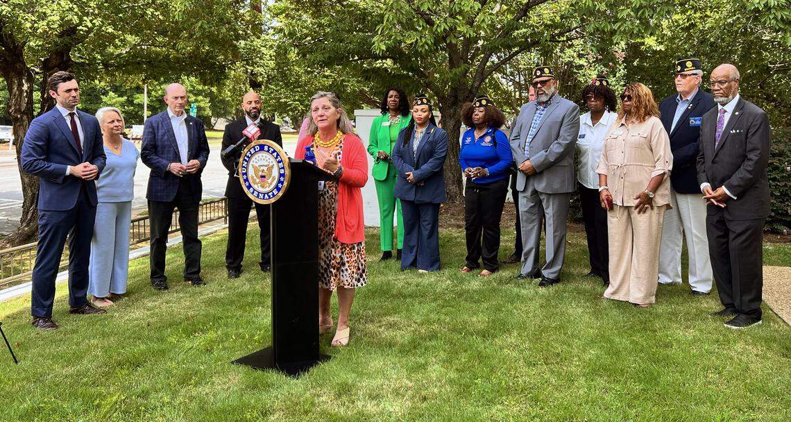 Pat Frey, vice president of Home for Good at the United Way of the Chattahoochee Valley speaks at the podium during a news conference Aug. 20, 2025, hosted by U.S. Sen. Jon Ossoff, D-Georgia, outside Heritage Tower in Columbus to announce President Donald Trump signed into law bipartisan legislation that Ossoff championed to help veterans experiencing financial hardship avoid foreclosure.