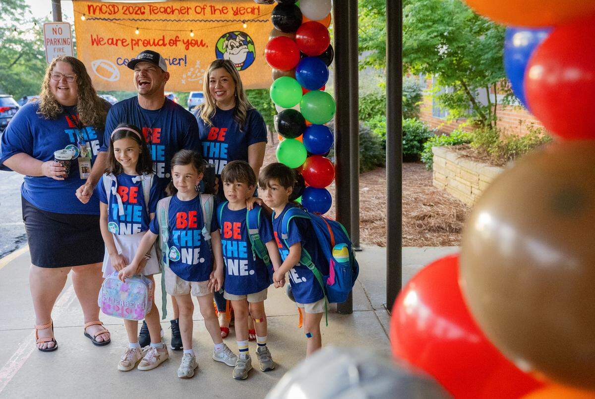 Clubview Elementary School teacher Chris Grier poses for a photo while greeting students arriving for school May 8, 2026, the day after the Muscogee Educational Excellence Foundation named him the Teacher of the Year in the Muscogee County School District.