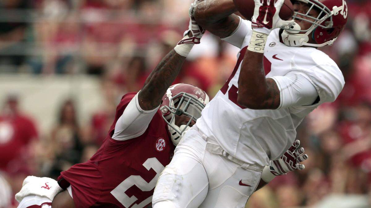 BUTCH DILL/Associated PressAlabama wide receiver ArDarius Stewart (13) catches a pass for a touchdown over Alabama defensive back Maurice Smith (21) during the first half of Alabama's spring football game April 18 in Tuscaloosa, Ala.