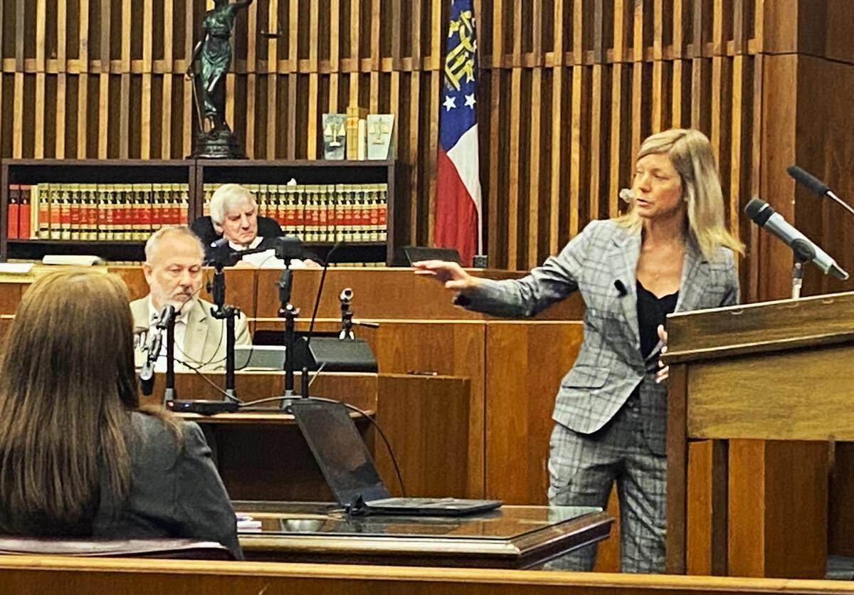 Defense attorney Jennifer Curry gestures toward client Ruben Hensley during closing arguments in his Columbus murder trial.
