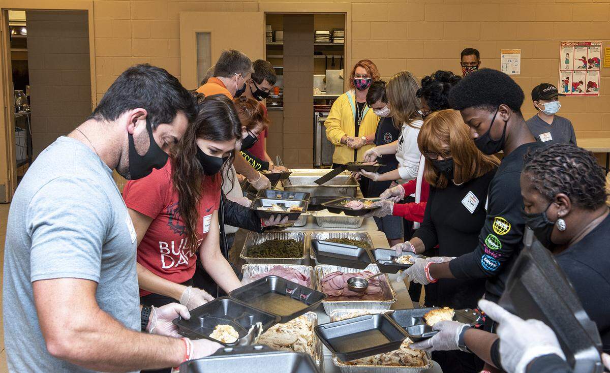 Valley Rescue Mission volunteers fill serving trays with turkey and other dishes in preparation of serving Thanksgiving dinner Thursday at Valley Rescue Mission in Columbus, Georgia.