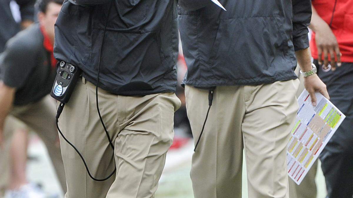 Georgia head coach Mark Richt rushes to to call a time out against Kentucky as offensive coordinator Brian Schottenheimer, second from left, looks up the field during the first half of an NCAA college football game, Saturday, Nov. 7, 2015, in Athens, Ga. Georgia won 27-3. (AP Photo/John Amis)