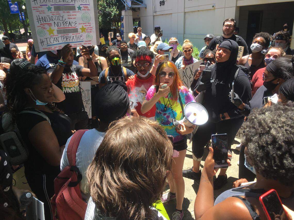 Over 200 people gathered in downtown Columbus, Georgia, May 31, 2020, to protest the death of George Floyd and support the Black Lives Matter movement. Columbus resident Skylar McMeans, pictured speaking into a megaphone, organized the protest. After marching up and down Broadway sidewalks, protesters gathered outside of the RiverCenter Parking Garage to share experiences of being black in America.