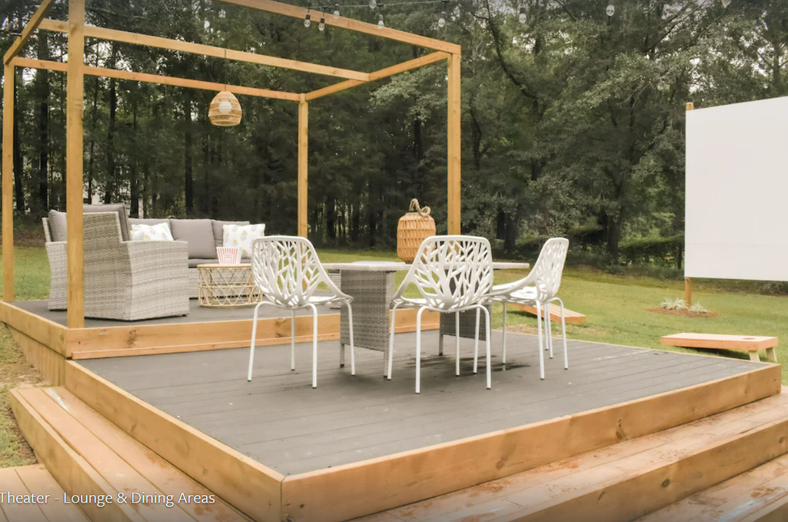 The custom built outdoor theater has a lounge, fire pit access and small dining area.
