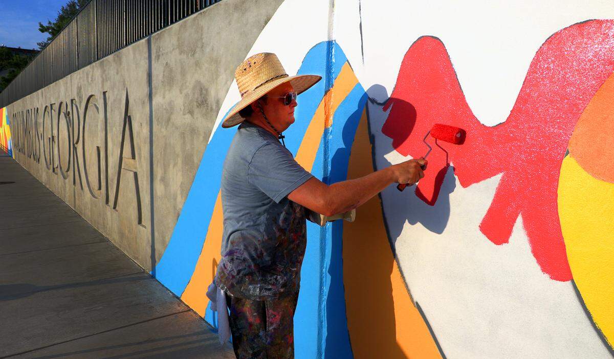 Chris Johnson, a muralist and retired Andrew College professor of art, is leading the design team in painting a mural along the Chattahoochee Riverwalk.The mural stretches along the riverbank’s three-tiered retaining wall where the Synovus Centre, 1111 Bay Ave., overlooks the Riverwalk between two of the most popular attractions on the riverfront: Waveshaper Island and Woodruff Park. 06/15/2023