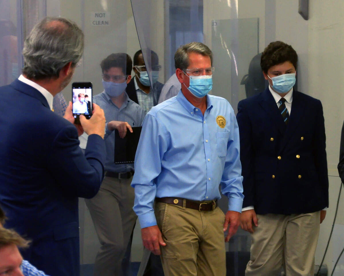 Georgia Gov. Brian Kemp, center, visited High Performance Product Engineering in Columbus, Georgia Wednesday afternoon. Kemp first toured the facility before making remarks and answering questions from the media.