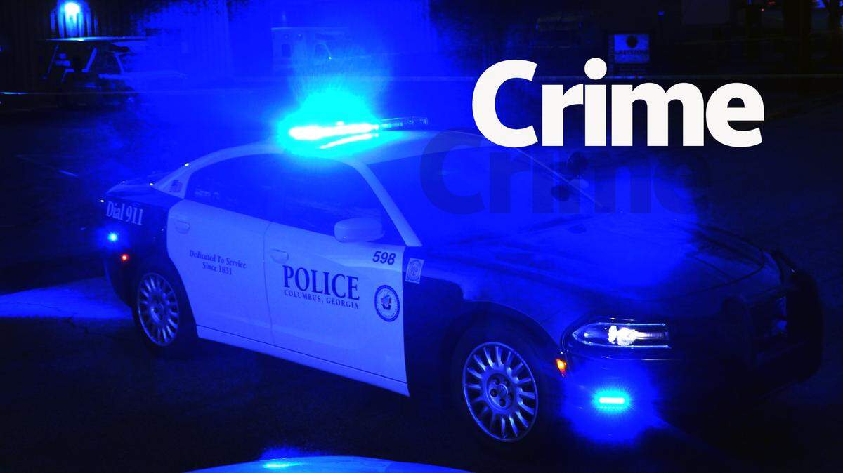 A Columbus Police Department patrol car blocks an intersection in Columbus, Georgia as investigators process a crime scene.