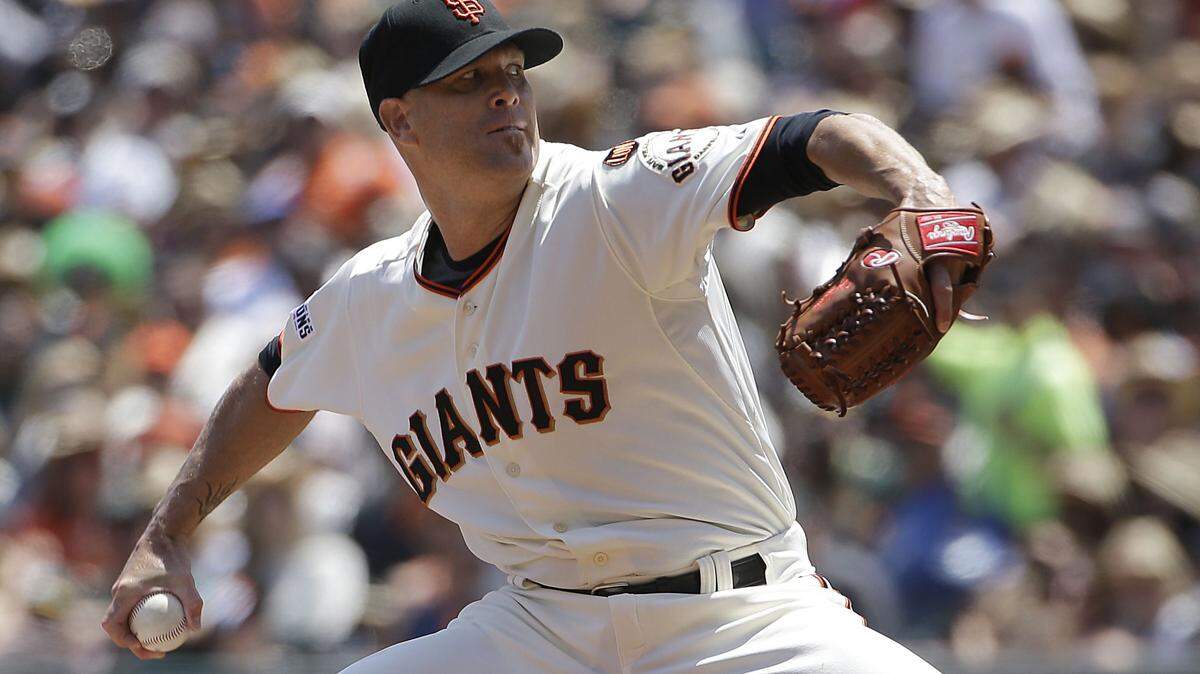 San Francisco Giants pitcher Tim Hudson throws against the Oakland Athletics during the third inning of a baseball game in San Francisco, Sunday, July 26, 2015. (AP Photo/Jeff Chiu)