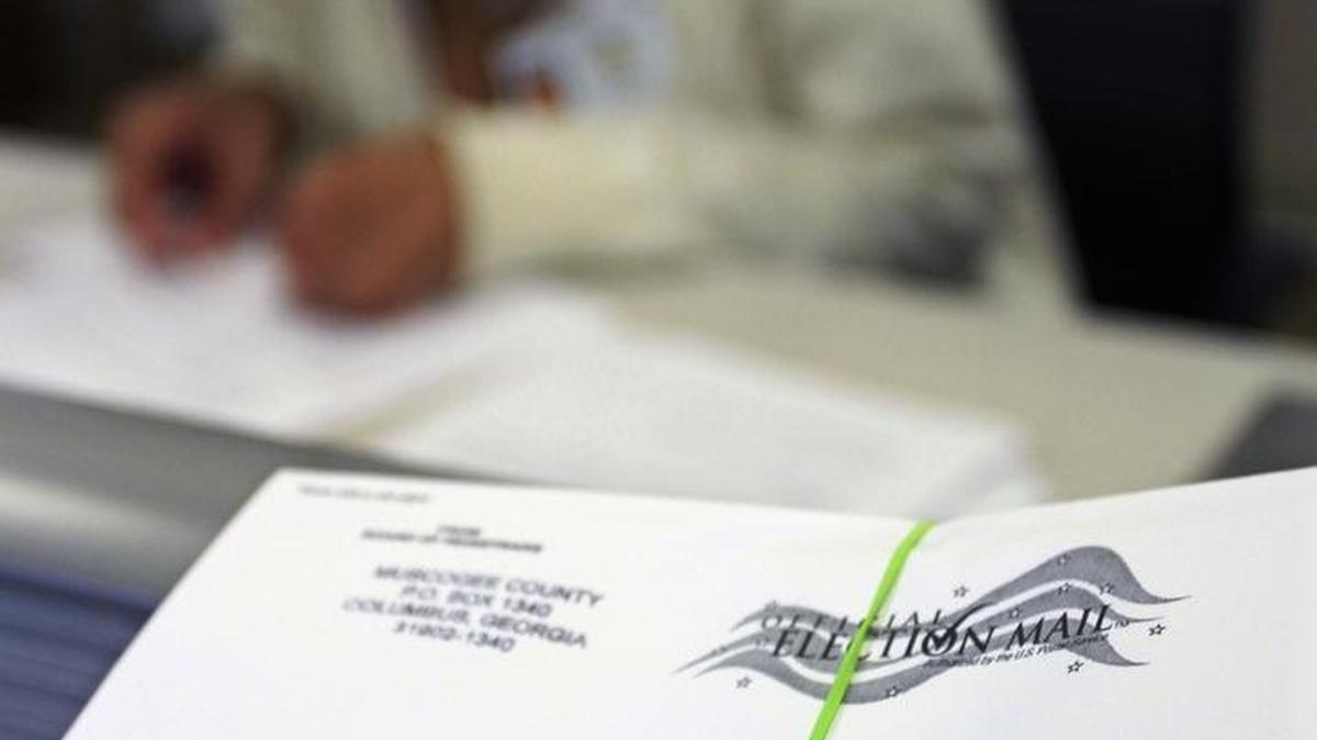 Leahya Felton prepares absentee ballots for mailing at the Muscogee County elections office.