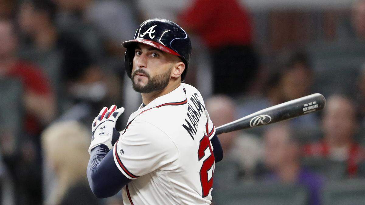 File-This Sept. 21, 2018, file photo shows Atlanta Braves right fielder Nick Markakis (22) batting against the Philadelphia Phillies during a baseball game in Atlanta. The Braves have agreed to one-year contract to bring back Markakis, a deal worth a guaranteed $6 million. Markakis’ deal, announced Tuesday, Jan. 22, 2019, includes a $4 million salary this year and $6 million club option for 2020 with a $2 million buyout. (AP Photo/John Bazemore, File)