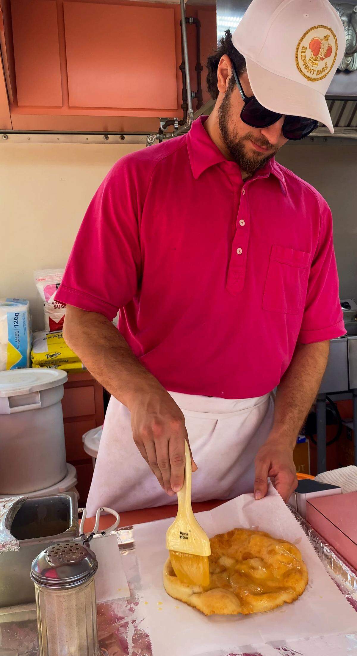 Vincent Carroll makes an elephant ear at the family’s food stand April 7, 2026, during the Spring Fling at the Columbus Civic Center.