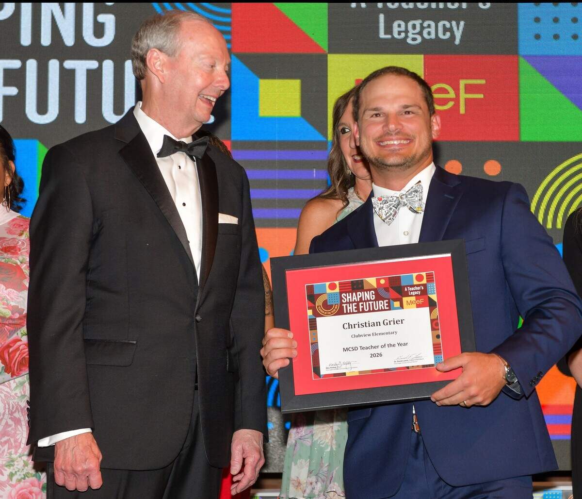 Clubview Elementary School physical education teacher Chris Grier, right, poses with Muscogee County School District superintendent David Lewis after the Muscogee Educational Excellence Foundation announced Grier as the 2026 MCSD Teacher of the Year during MEEF’s gala May 7 at the Columbus Convention & Trade Center.